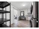 Laundry room with shelving, modern washer and dryer, leading to exercise room at 1489 77Th N Ave, St Petersburg, FL 33702