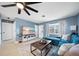 Inviting living room with a large smart TV, ceiling fan, and comfortable blue sofa at 1489 77Th N Ave, St Petersburg, FL 33702