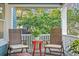 Cozy front porch featuring comfortable seating and views of lush greenery at 202 13Th N Ave, St Petersburg, FL 33701