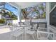 Well-appointed outdoor kitchen with a stainless steel grill, dining area, and ample counter space for entertaining at 230 Tucker St, Safety Harbor, FL 34695