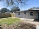 View of the backyard with a wood fence and covered patio at 2406 Cool Rd, Holiday, FL 34690