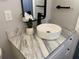 Bathroom vanity with a white vessel sink and black faucet at 2406 Cool Rd, Holiday, FL 34690