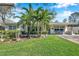 Charming single-story home with a well-maintained lawn and lush palm tree landscaping creating curb appeal at 2731 56Th N Ln, St Petersburg, FL 33710