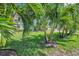 The manicured lawn in the front yard is adorned with mature palm trees, enhancing the home's curb appeal at 2731 56Th N Ln, St Petersburg, FL 33710