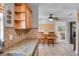 Open kitchen with tile backsplash, wood cabinets, and counter with view to the dining room at 2731 56Th N Ln, St Petersburg, FL 33710