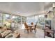 Cozy sunroom with tile floors, a glass table, and floor-to-ceiling windows providing views of the outdoor landscape at 2731 56Th N Ln, St Petersburg, FL 33710