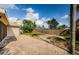 The brick patio overlooks the lawn with wood fence in this backyard at 280 Cherry Laurel Dr, Palm Harbor, FL 34683