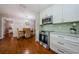 Kitchen with a view of the dining room, stainless steel appliances, and white cabinetry at 280 Cherry Laurel Dr, Palm Harbor, FL 34683