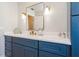 Bathroom with a modern vanity, ample storage, and stylish lighting fixtures at 2821 Coral Way, Punta Gorda, FL 33950