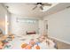 Bright bedroom featuring a ceiling fan, skylight, and fresh white walls at 2821 Coral Way, Punta Gorda, FL 33950