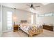 Bedroom features a ceiling fan, hardwood floors, and bright, neutral walls at 2821 Coral Way, Punta Gorda, FL 33950