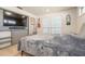 Cozy bedroom featuring a mounted TV, window with blinds, and unique wall decor at 2821 Coral Way, Punta Gorda, FL 33950