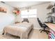 Bright bedroom featuring a computer desk, a mounted shelf, and natural light at 2821 Coral Way, Punta Gorda, FL 33950