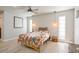 Bedroom features a ceiling fan, hardwood floors, and bright, neutral walls at 2821 Coral Way, Punta Gorda, FL 33950