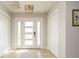 Bright foyer features a modern light fixture, a contemporary front door, and neutral paint at 2821 Coral Way, Punta Gorda, FL 33950