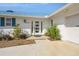 Inviting front entrance with a modern white door and clean, well-maintained landscaping at 2821 Coral Way, Punta Gorda, FL 33950