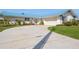 Charming single-story home with a driveway, front lawn, crisp white paint, blue shutters, and a matching light-blue metal roof at 2821 Coral Way, Punta Gorda, FL 33950