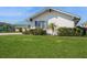 Charming single-story home with manicured green lawn and a stylish light-blue metal roof at 2821 Coral Way, Punta Gorda, FL 33950
