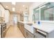 Modern kitchen featuring a farmhouse sink, quartz countertops, and stainless steel appliances at 2821 Coral Way, Punta Gorda, FL 33950