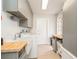 Well-organized laundry room featuring a sink and ample cabinet storage at 2821 Coral Way, Punta Gorda, FL 33950