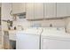 Efficient laundry area with a washer, dryer, and a convenient utility sink at 2821 Coral Way, Punta Gorda, FL 33950