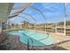 Inviting screened-in pool area overlooking a canal, perfect for relaxation and entertaining at 2821 Coral Way, Punta Gorda, FL 33950