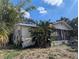 A cozy one-story home featuring a screened porch and lush tropical plants at 3201 N 15Th St, Tampa, FL 33605