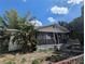 Quaint one-story house with a covered porch and tropical foliage adding charm at 3201 N 15Th St, Tampa, FL 33605