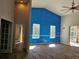 Living room with high ceilings, tile floors, and sliding glass doors leading to the lanai at 3801 Bramblewood Blvd, Land O Lakes, FL 34639