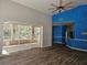 Living room with high ceilings, tile floors, and sliding glass doors leading to the lanai at 3801 Bramblewood Blvd, Land O Lakes, FL 34639