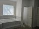 Bright primary bathroom with a luxurious soaking tub and tile surround at 3801 Bramblewood Blvd, Land O Lakes, FL 34639