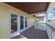 An open-air balcony offers picturesque views with its brown wood-look flooring and white railing at 5092 Beach Se Dr # D, St Petersburg, FL 33705