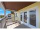 View of a beautiful outdoor balcony with railing and door to the interior with a view of the surrounding buildings at 5092 Beach Se Dr # D, St Petersburg, FL 33705