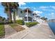 Exterior view of two-story home with white stairs, porch, and manicured yard at 5092 Beach Se Dr # D, St Petersburg, FL 33705