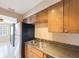 Kitchen with stainless steel refrigerator, double basin sink and light wood cabinets at 5092 Beach Se Dr # D, St Petersburg, FL 33705
