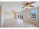 Open living area with tiled floors, neutral paint, ceiling fans and balcony access at 5092 Beach Se Dr # D, St Petersburg, FL 33705