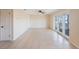 Bright living room with tile flooring, white doors, and glass sliding doors to the outdoor balcony at 5092 Beach Se Dr # D, St Petersburg, FL 33705