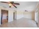 Spacious living area featuring tile flooring, ceiling fans, and an open doorway to the kitchen at 5092 Beach Se Dr # D, St Petersburg, FL 33705