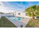 Backyard with a pool, privacy fence, and tropical landscaping at 6304 Seabreeze Dr, Port Richey, FL 34668