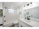 Updated bathroom features a new vanity, fixtures, mirror, and tiled shower-tub combo at 6304 Seabreeze Dr, Port Richey, FL 34668