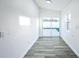 Bonus room features a sliding glass door and a window to the back yard at 6304 Seabreeze Dr, Port Richey, FL 34668