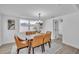 Dining room with seating for six, a chandelier, and bright white walls at 6304 Seabreeze Dr, Port Richey, FL 34668