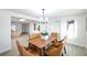 Dining room with a chandelier and seating for six adjacent to living room at 6304 Seabreeze Dr, Port Richey, FL 34668