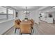 Dining room with a chandelier and seating for six adjacent to a modern kitchen at 6304 Seabreeze Dr, Port Richey, FL 34668