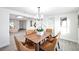 Dining room with a chandelier and seating for six adjacent to living room at 6304 Seabreeze Dr, Port Richey, FL 34668