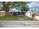Charming single-story home features a stone facade and a well-maintained front yard with mature trees at 6304 Seabreeze Dr, Port Richey, FL 34668