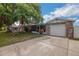 A lovely single-story home with stone accents, a garage, and lush landscaping for curb appeal at 6304 Seabreeze Dr, Port Richey, FL 34668