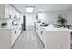 Bright, open kitchen with white cabinetry, modern appliances, and a spacious island with bar seating at 6304 Seabreeze Dr, Port Richey, FL 34668