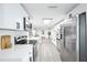 Modern kitchen featuring white cabinetry, stainless steel appliances, and ample counter space at 6304 Seabreeze Dr, Port Richey, FL 34668