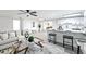 Bright, open living room with stylish furniture, seamlessly connected to the kitchen with a breakfast bar at 6304 Seabreeze Dr, Port Richey, FL 34668